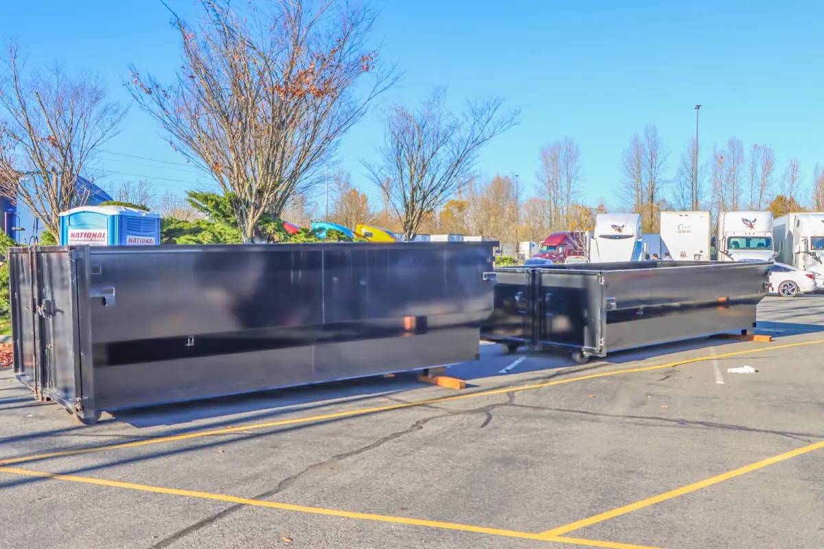 Professional dumpster rental service with roll-off container on residential driveway in Sandston